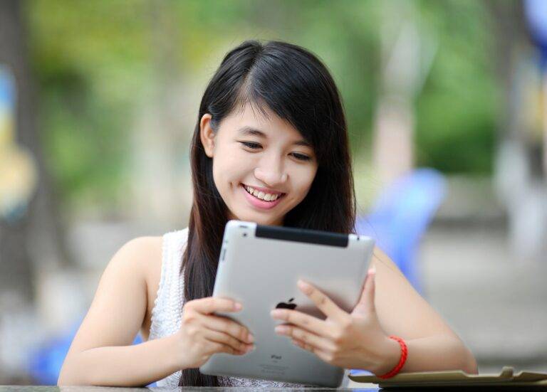 girl looking at tablet smiling