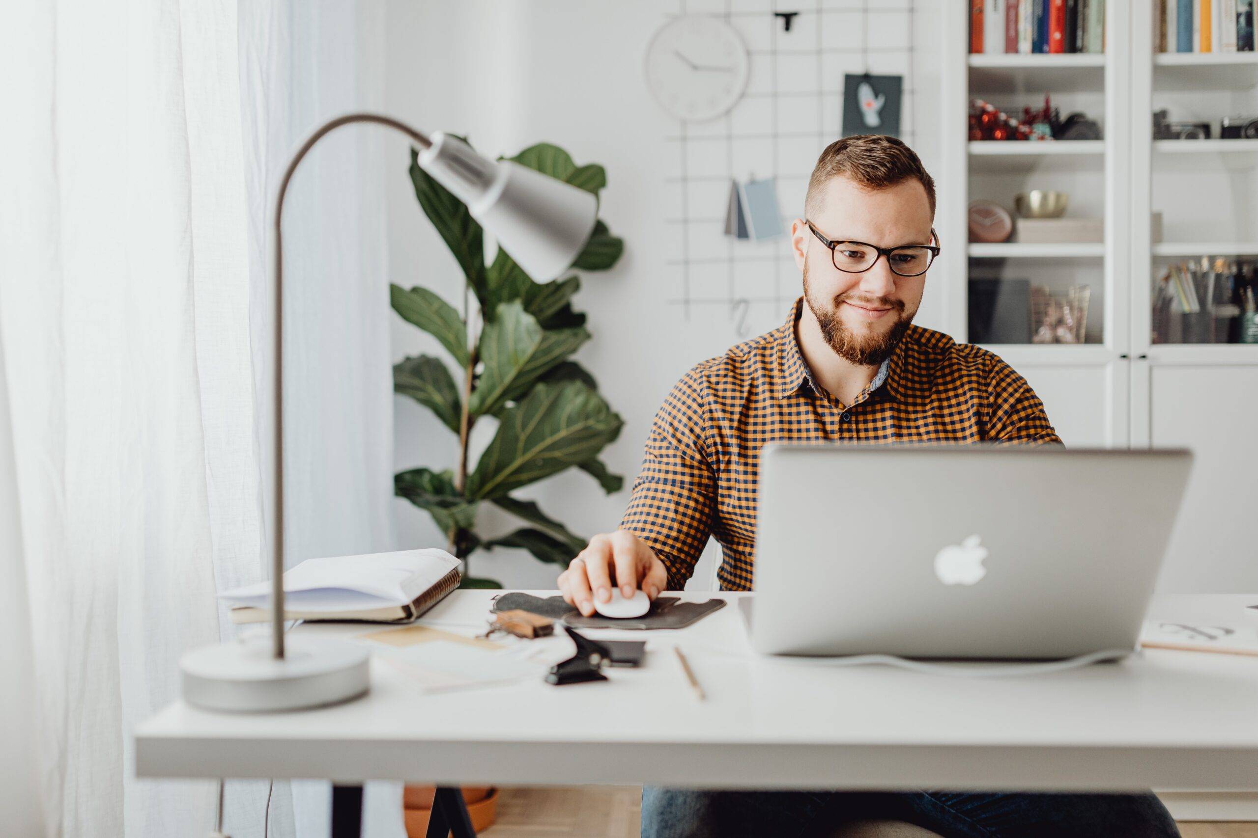 man smiling working at computer