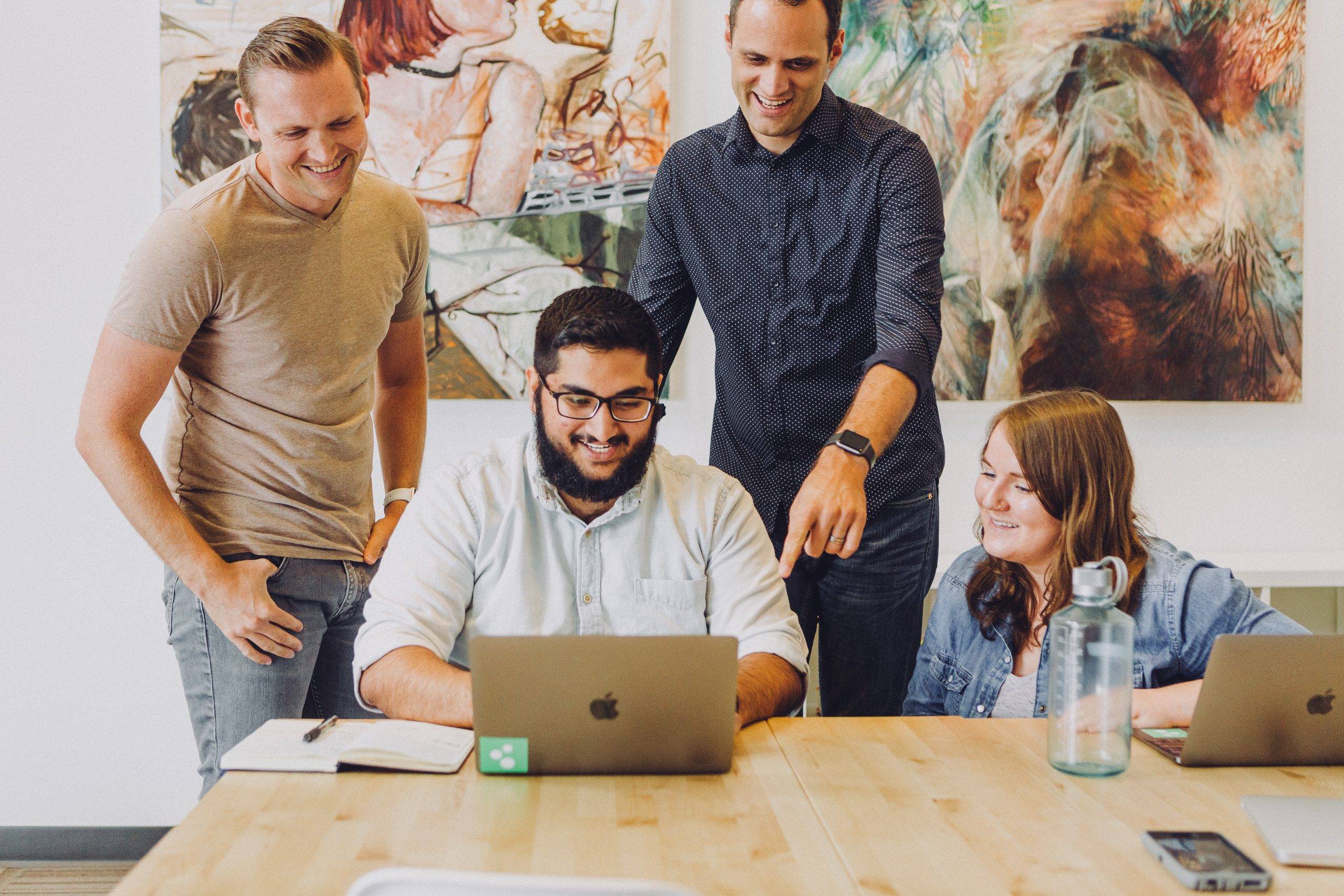 happy people looking at a computer