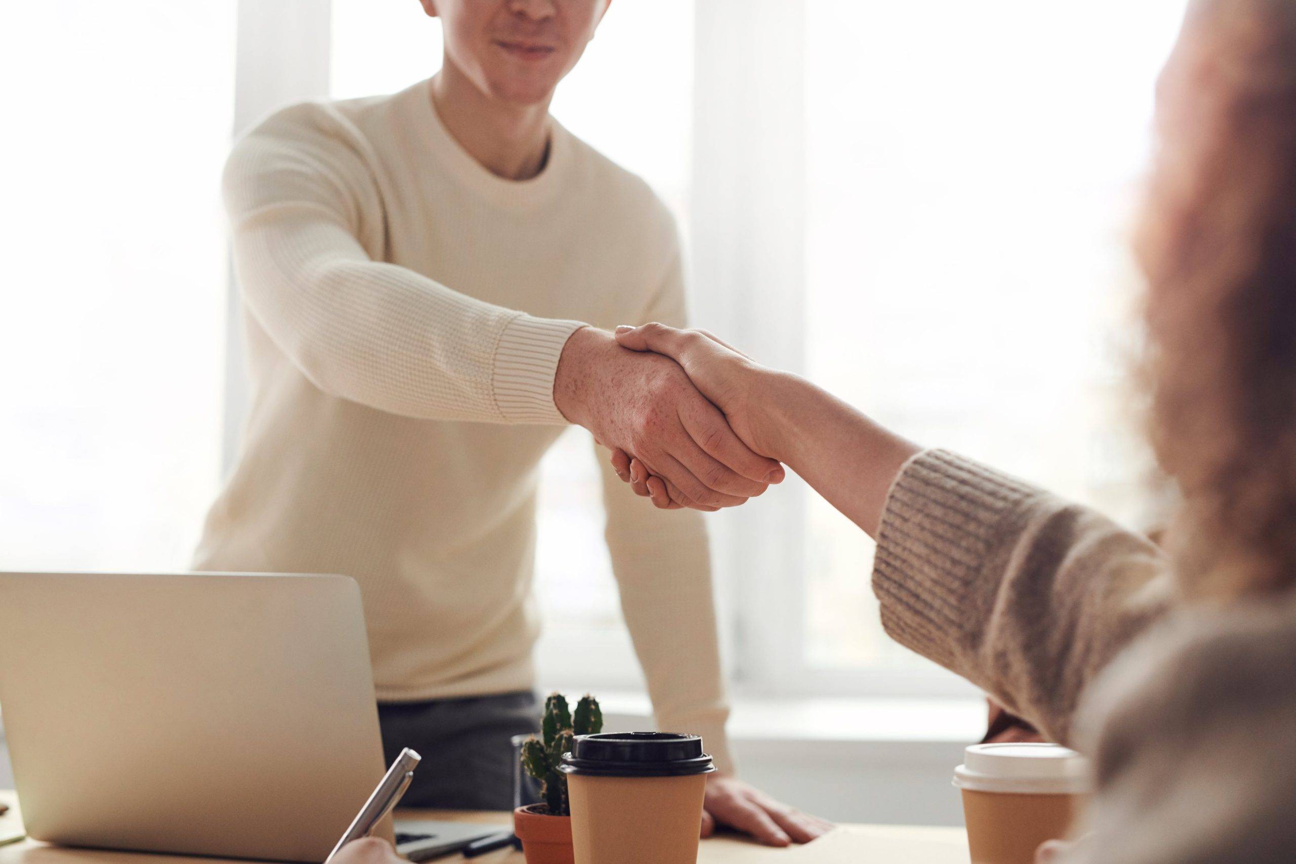 close up of two people shaking hands