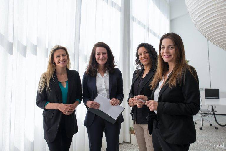 4 business women smiling