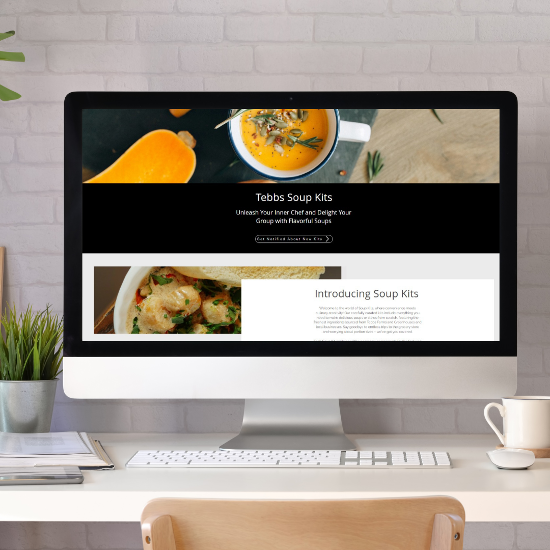 computer screen with a website showing soups on a white desk